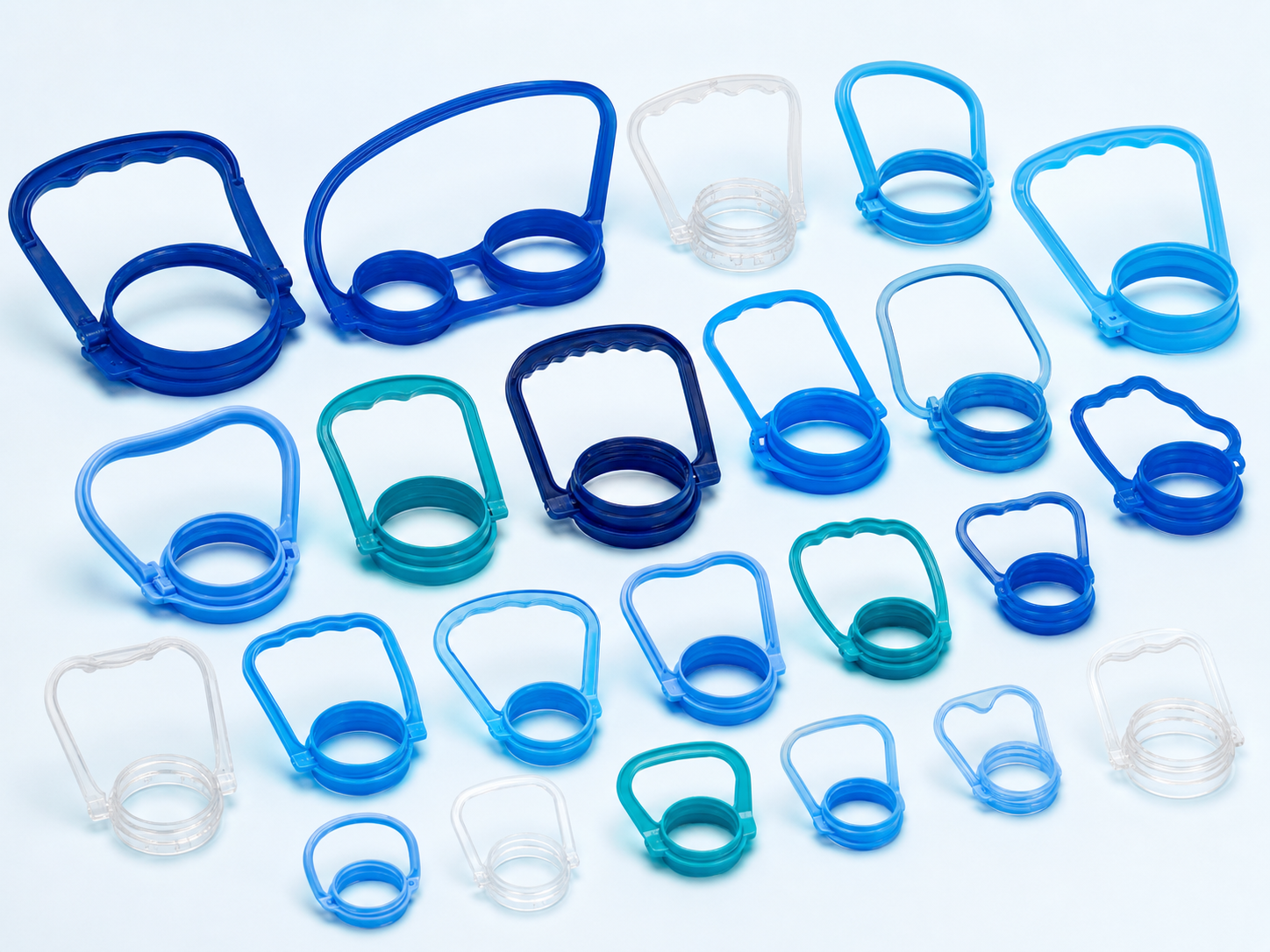 Large assortment of plastic bottle handles in many ring diameters and grip sizes